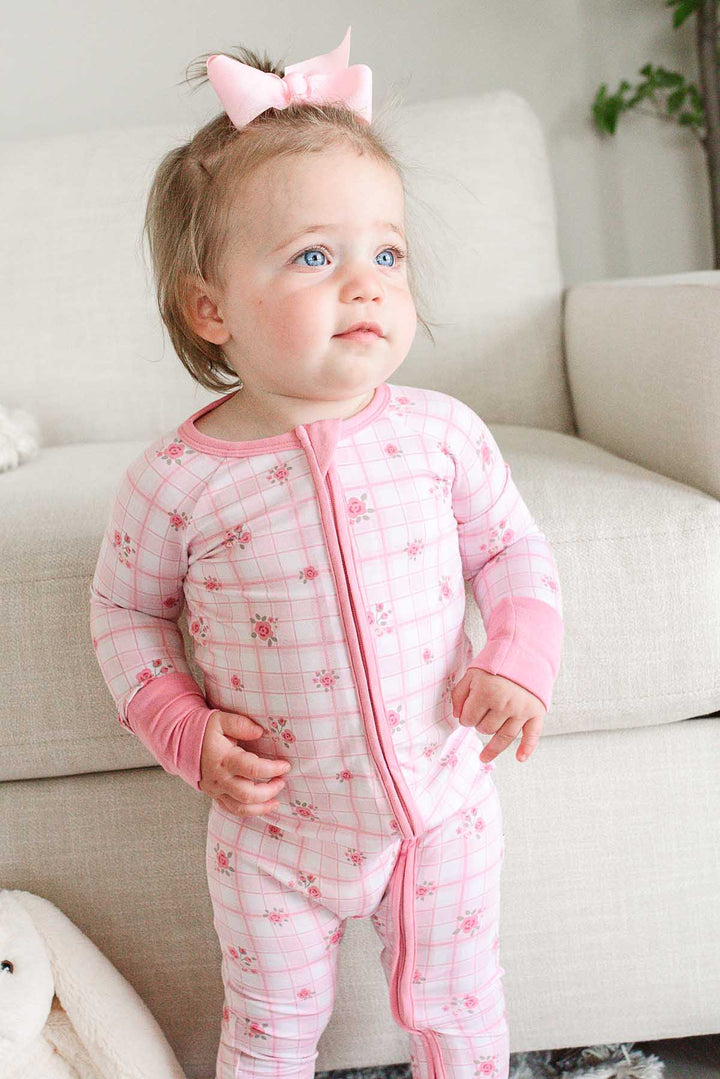 Toddler looking away wearing Primrose Plaid zip romper