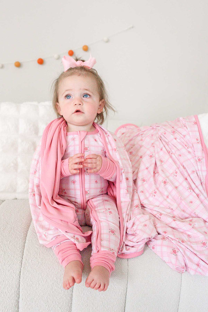 Toddler with Primrose Plaid blanket wrapped around shoulders
