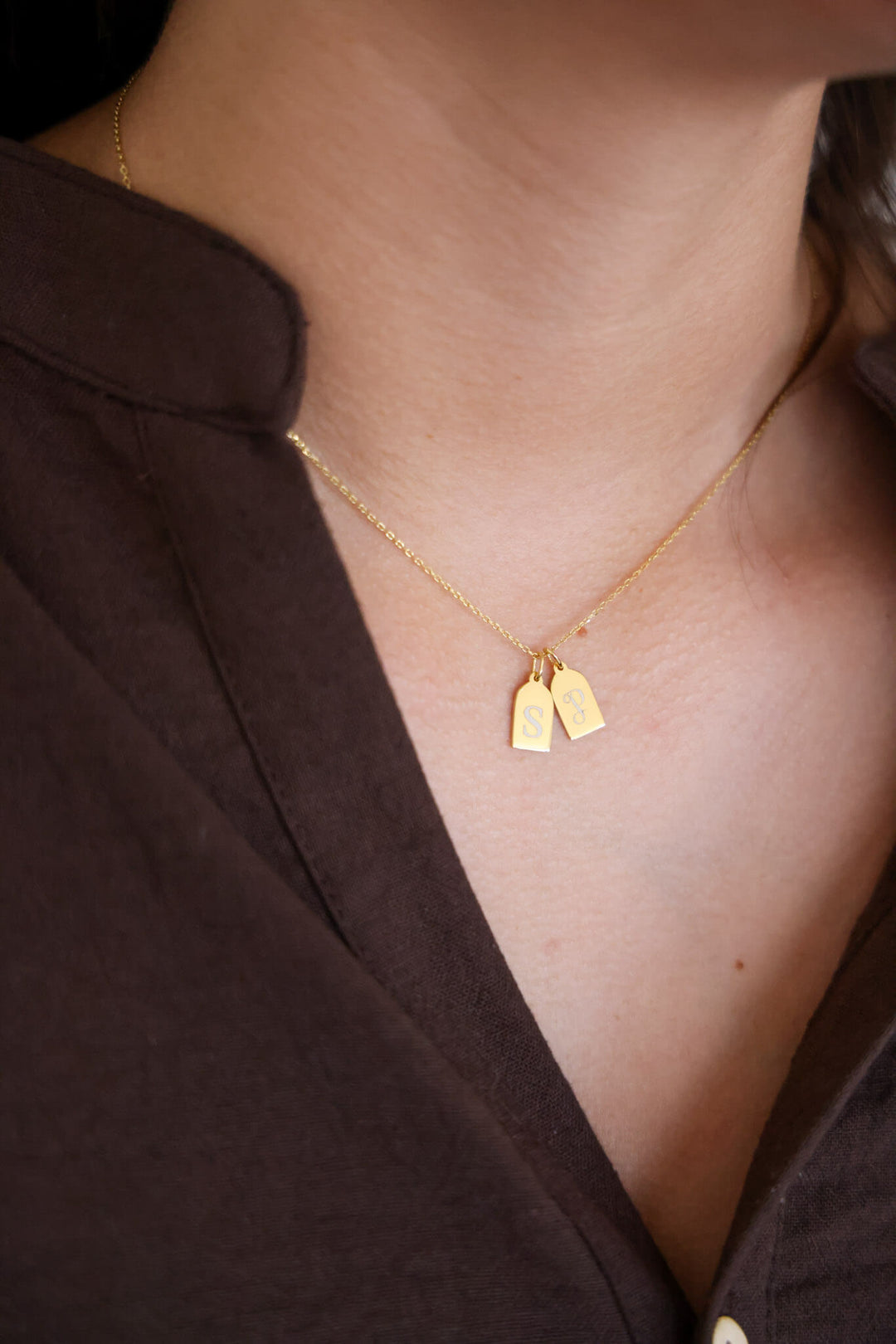 gold tag necklace with additional charm 