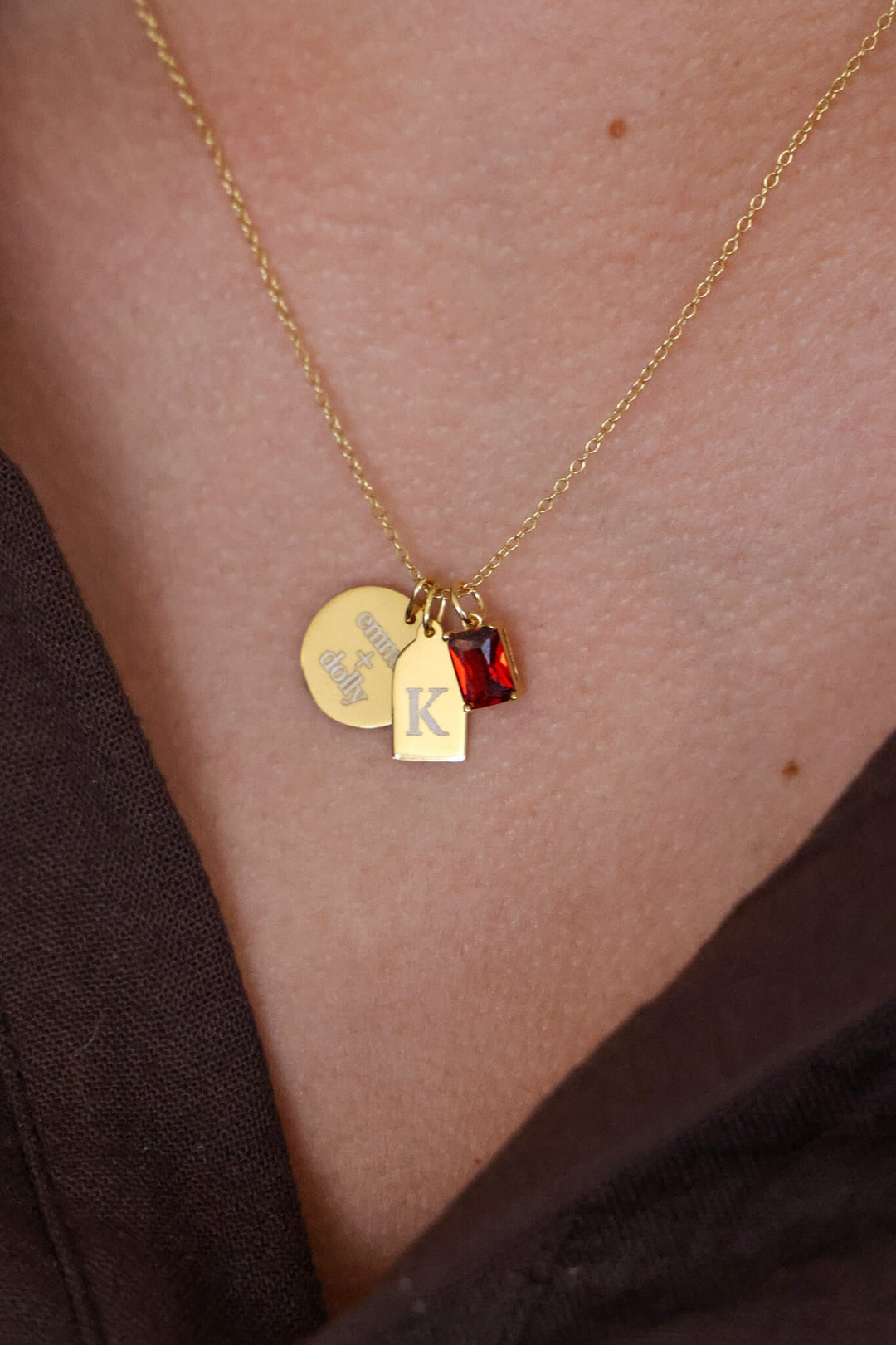 engraved gold necklace with red birthstone