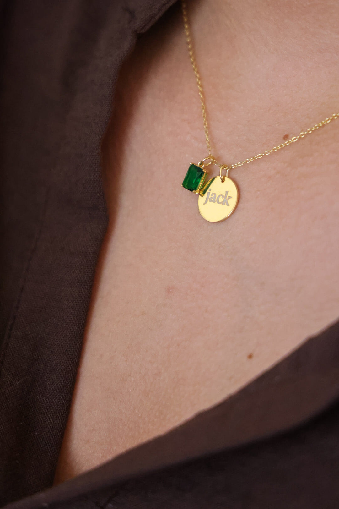 gold engraved circle charm necklace with green birthstone