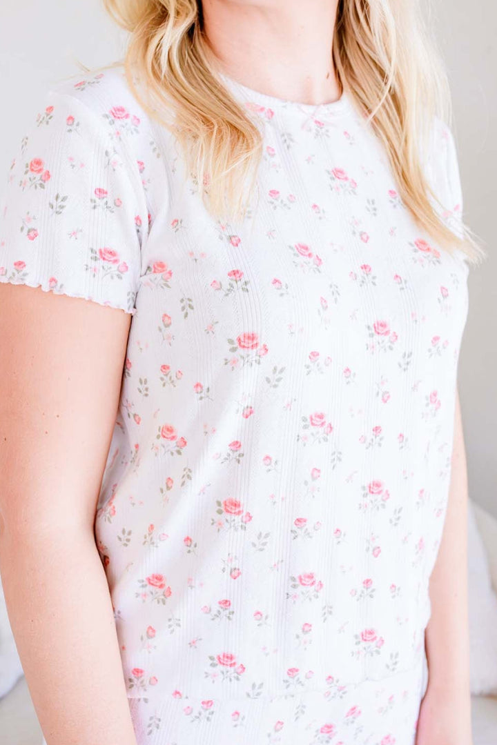 Caden Lane Rose Garden pointelle pajama top, close-up of white floral pattern on woman's matching mommy and me pajamas