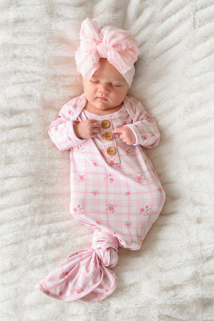 Baby in Primrose Plaid knot gown with tied bottom on fluffy blanket