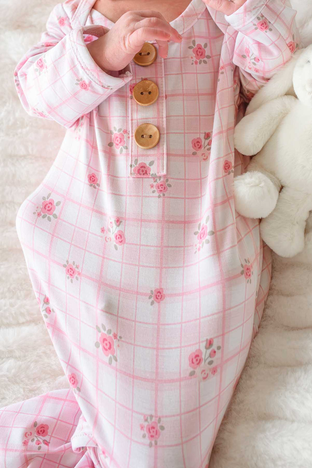 Close-up of wooden button and floral plaid fabric detail on knot gown