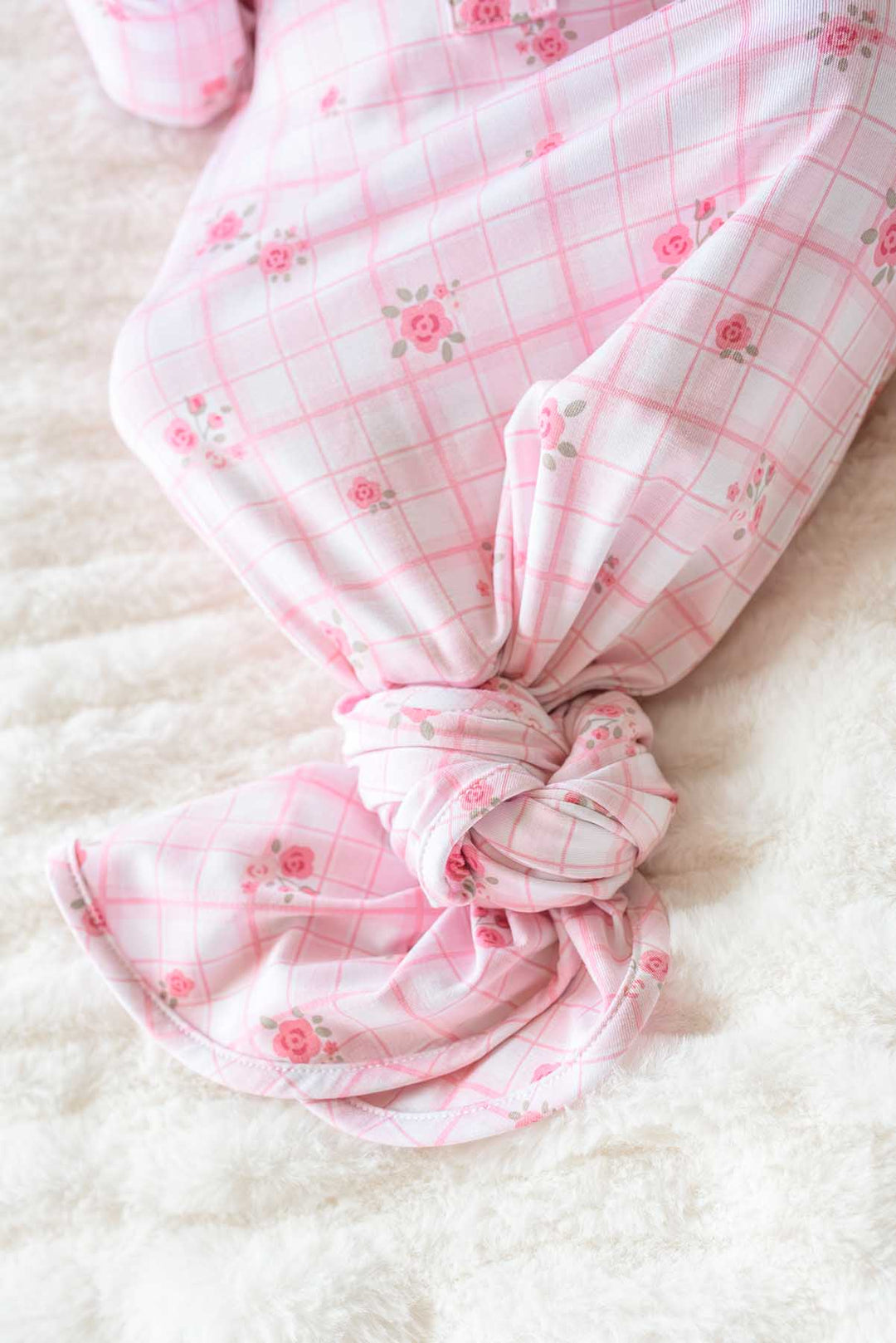 Close-up of knotted gown bottom showing Primrose Plaid rose print