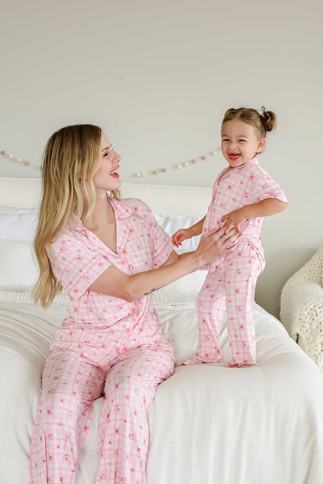 Mother and daughter beaming together in Primrose Plaid pajamas