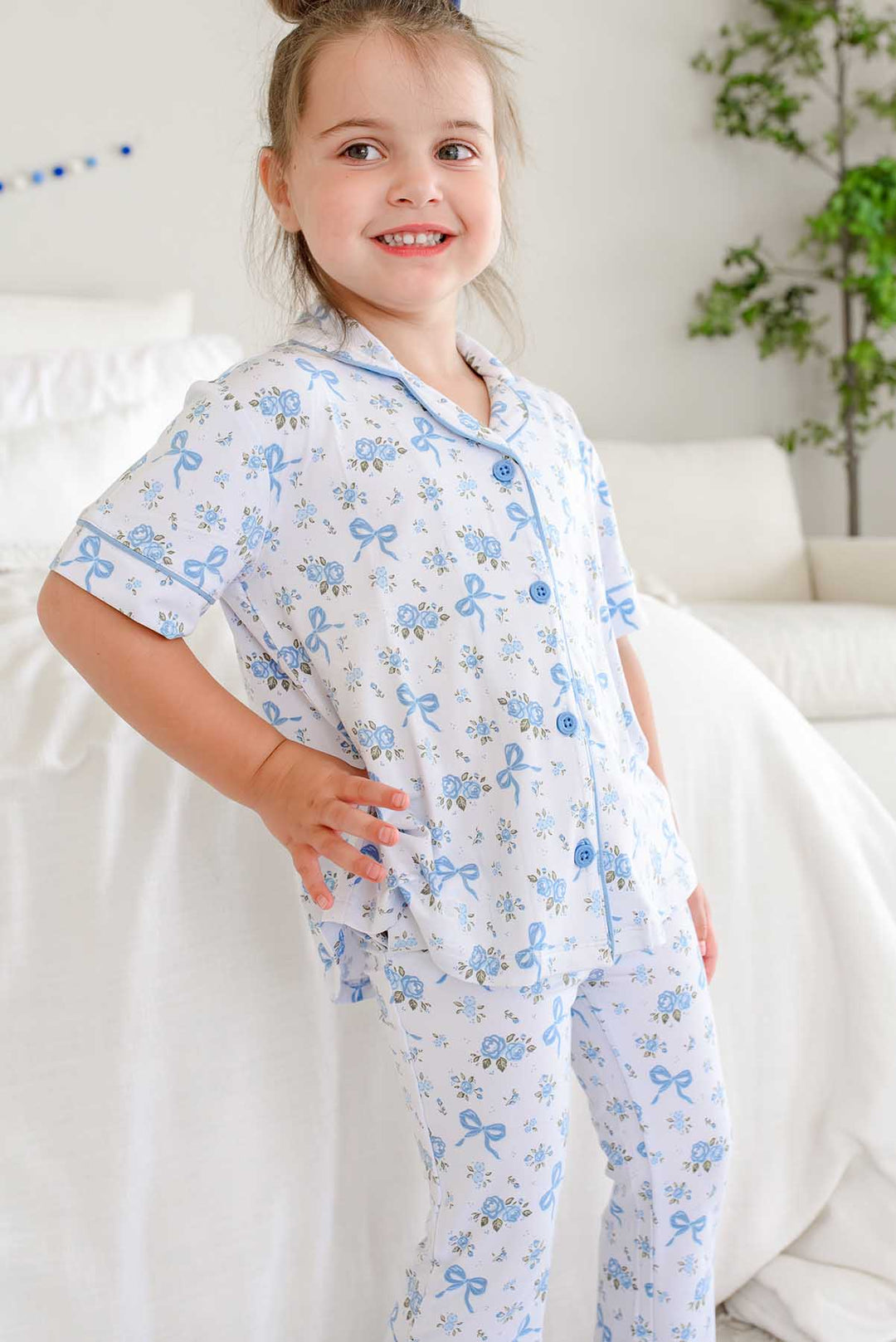 girl wearing tied in blooms short sleeve and flare pant lounge set in tied in blooms