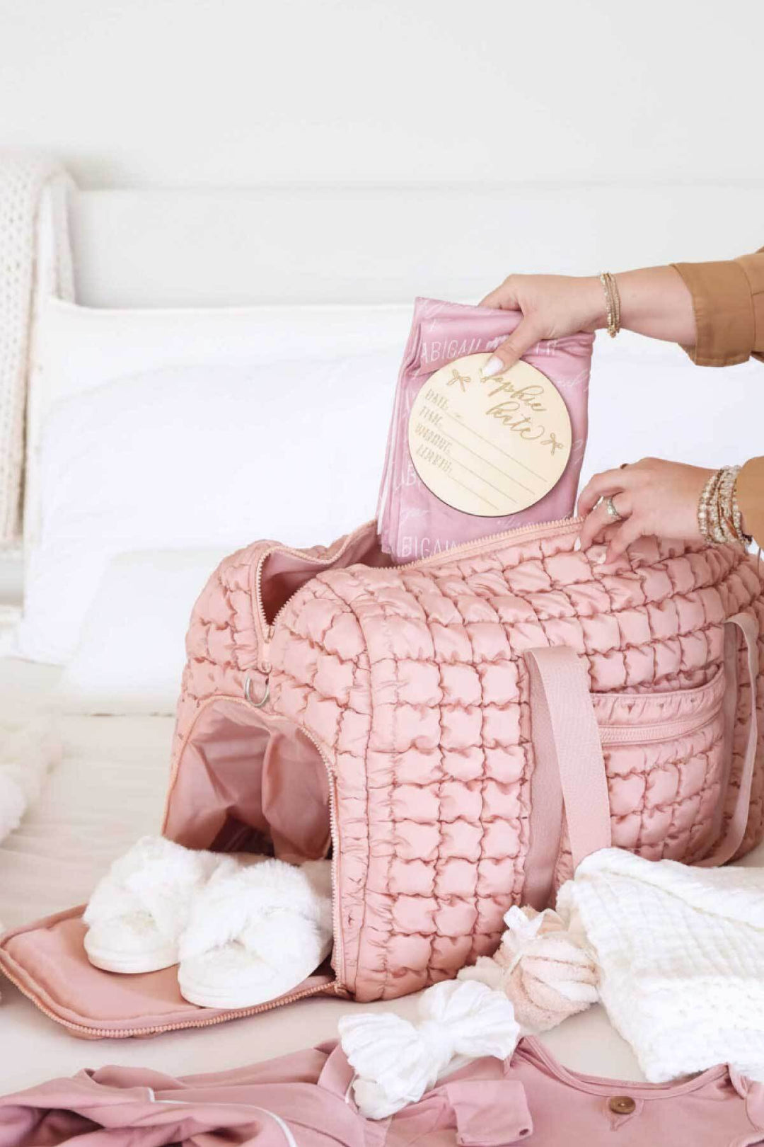 pink quilted Caden Lane weekender bag with long shoulder strap