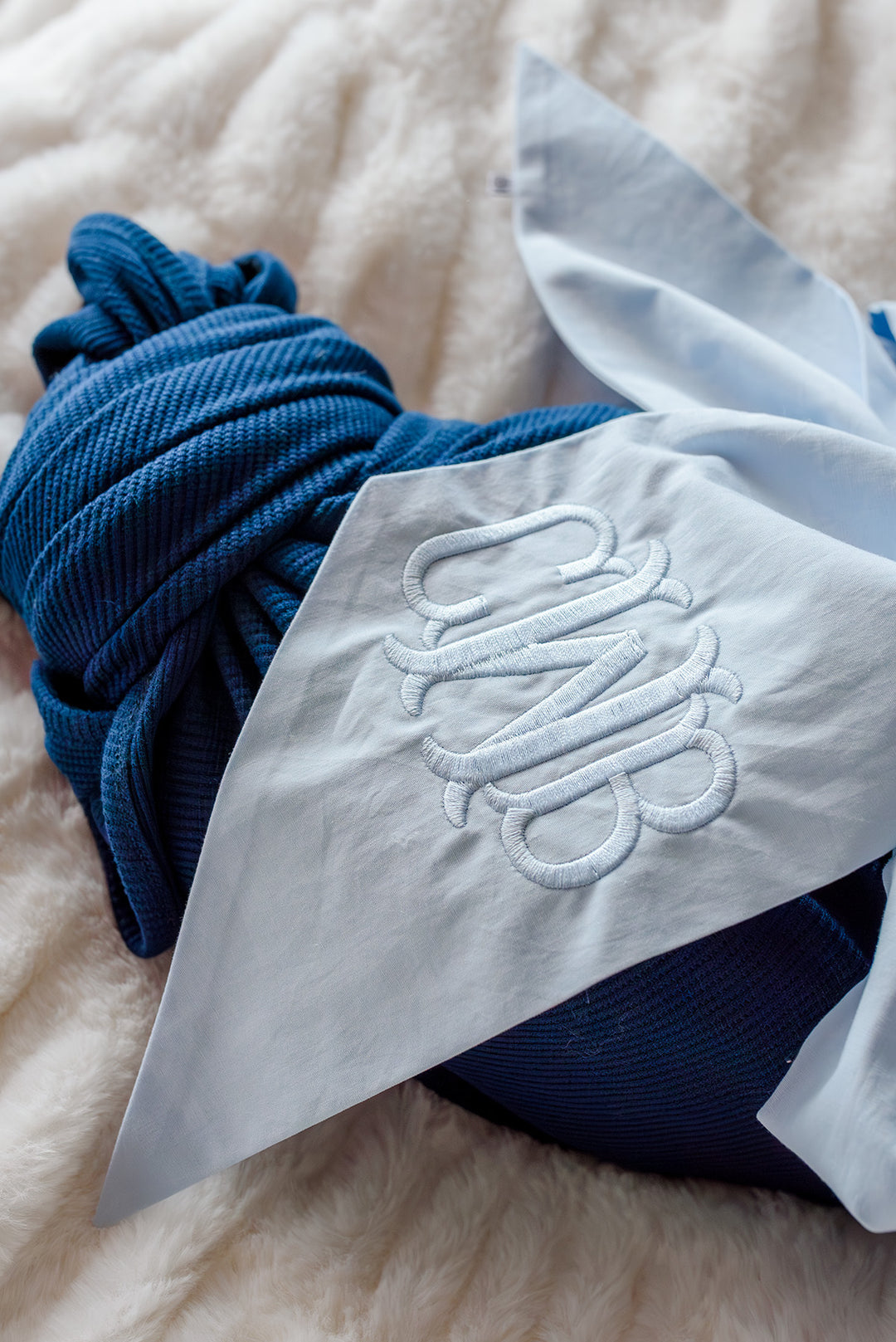 closeup of light blue newborn sash with monogram