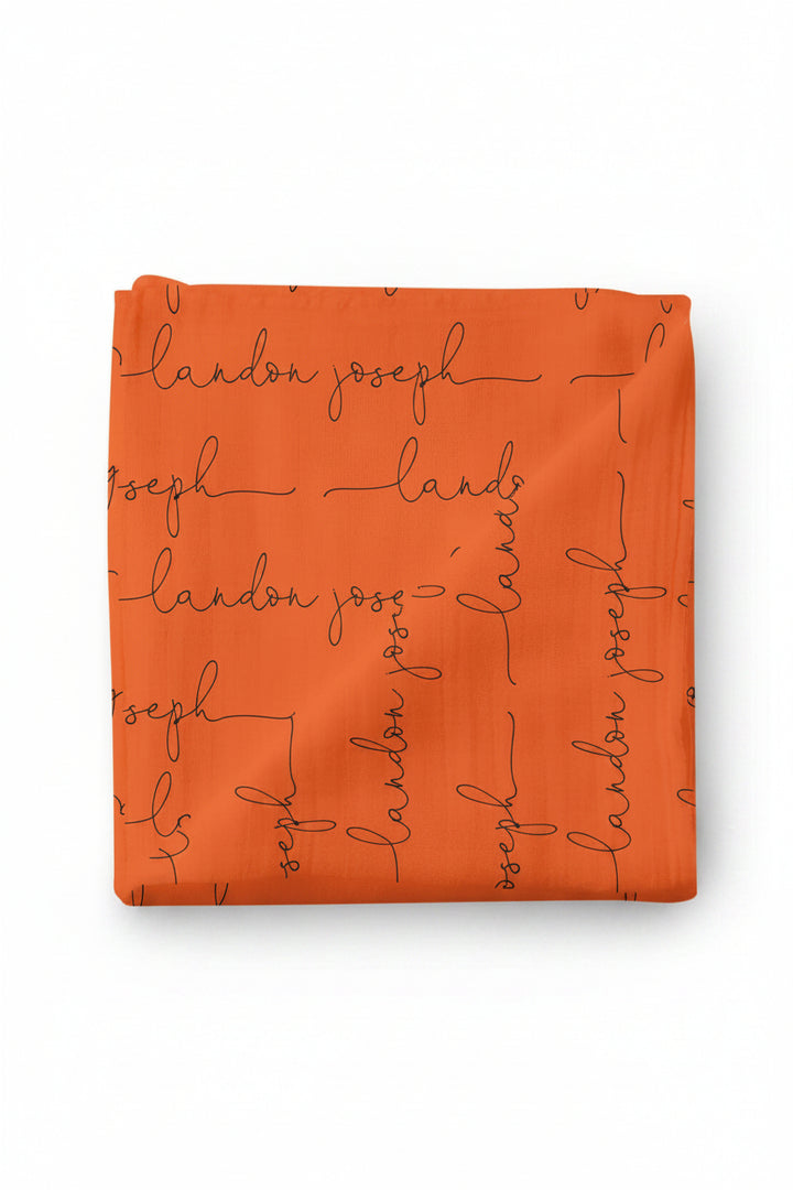 orange and black personalized swaddle script 