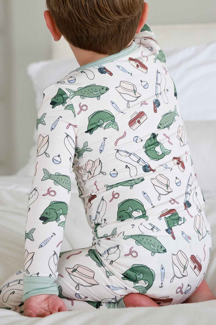 Back view of toddler wearing the Off The Hook two piece pajama set showing full back of long sleeve top and pants