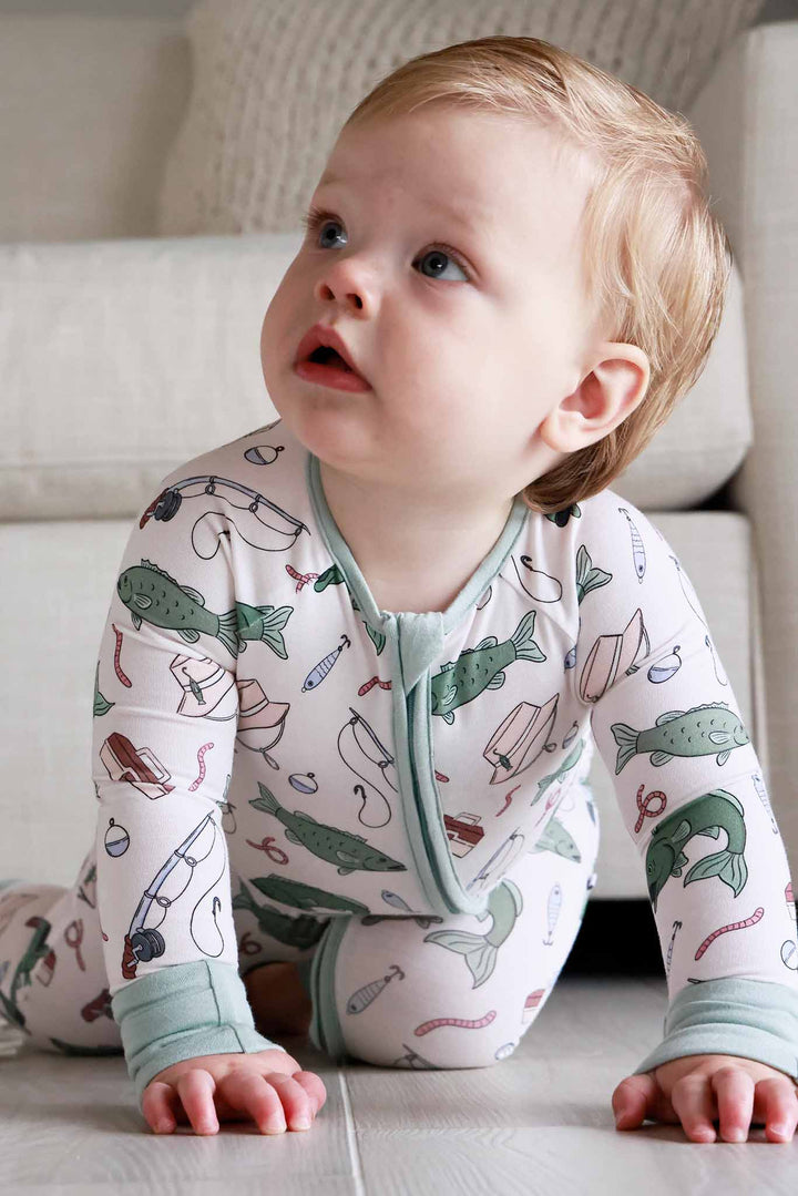 Baby crawling and wearing the Off The Hook convertible zip romper with fishing themed print