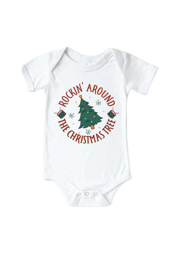 Caden Lane's white "Rockin' Around the Christmas Tree" baby onesie featuring a decorated Christmas tree with drums and snowflakes, laid flat.