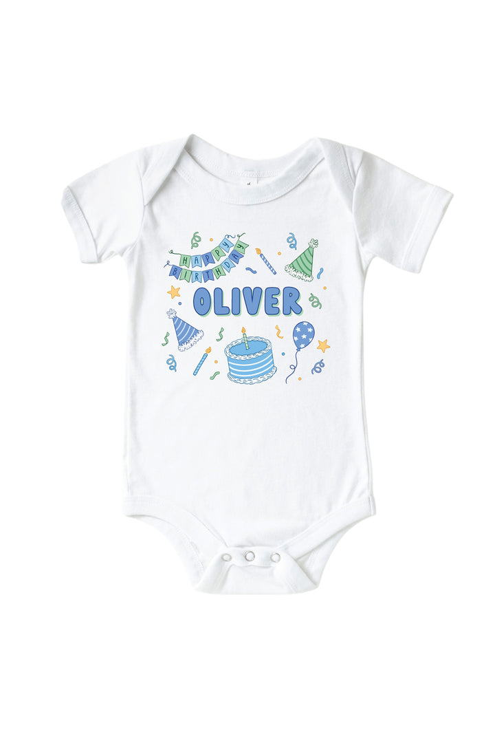 Caden Lane personalized Birthday Bash white baby bodysuit with a blue and green "Happy Birthday" banner, party hats, cake, and the name "Oliver" in blue.