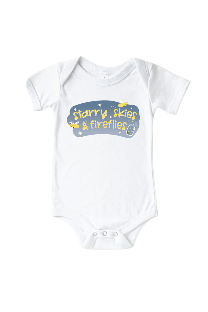Front view of a Caden Lane white short-sleeve graphic bodysuit with a "Starry Skies &amp; Fireflies" graphic featuring yellow fireflies, stars, and a glowing jar.