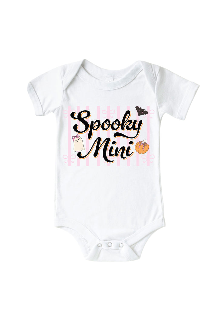 White baby bodysuit printed with 'Spooky Mini' text and Halloween graphics of a pumpkin, bat, and ghost.