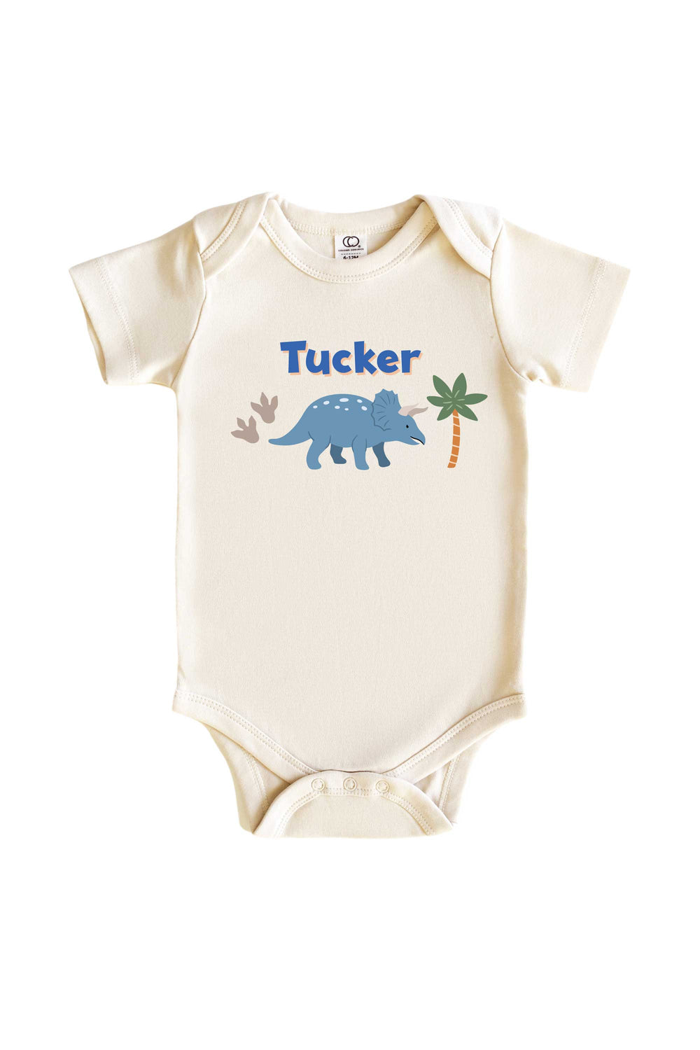 Natural cream baby bodysuit with blue triceratops dinosaur graphic, palm tree accents, and personalized name in blue lettering