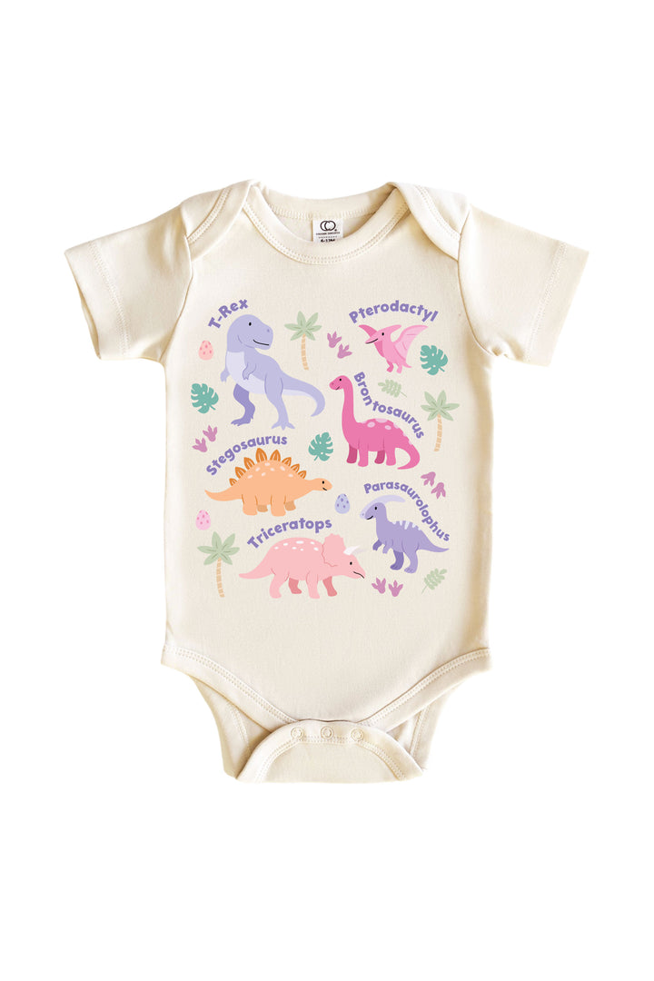 Natural cream baby bodysuit with multiple named pastel dinosaurs including T-Rex, Pterodactyl, Brontosaurus, Stegosaurus, and Triceratops in pink and purple with leaf accents