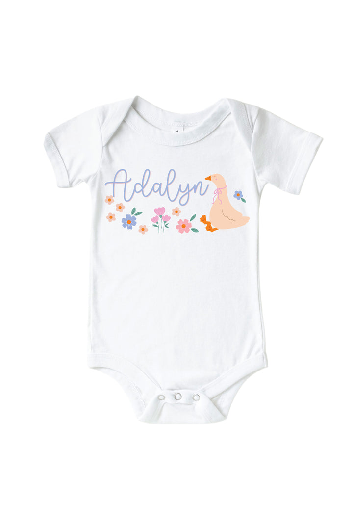 White baby bodysuit mockup with personalized name Adalyn and Lucy Goosy goose and floral graphic design on a white background