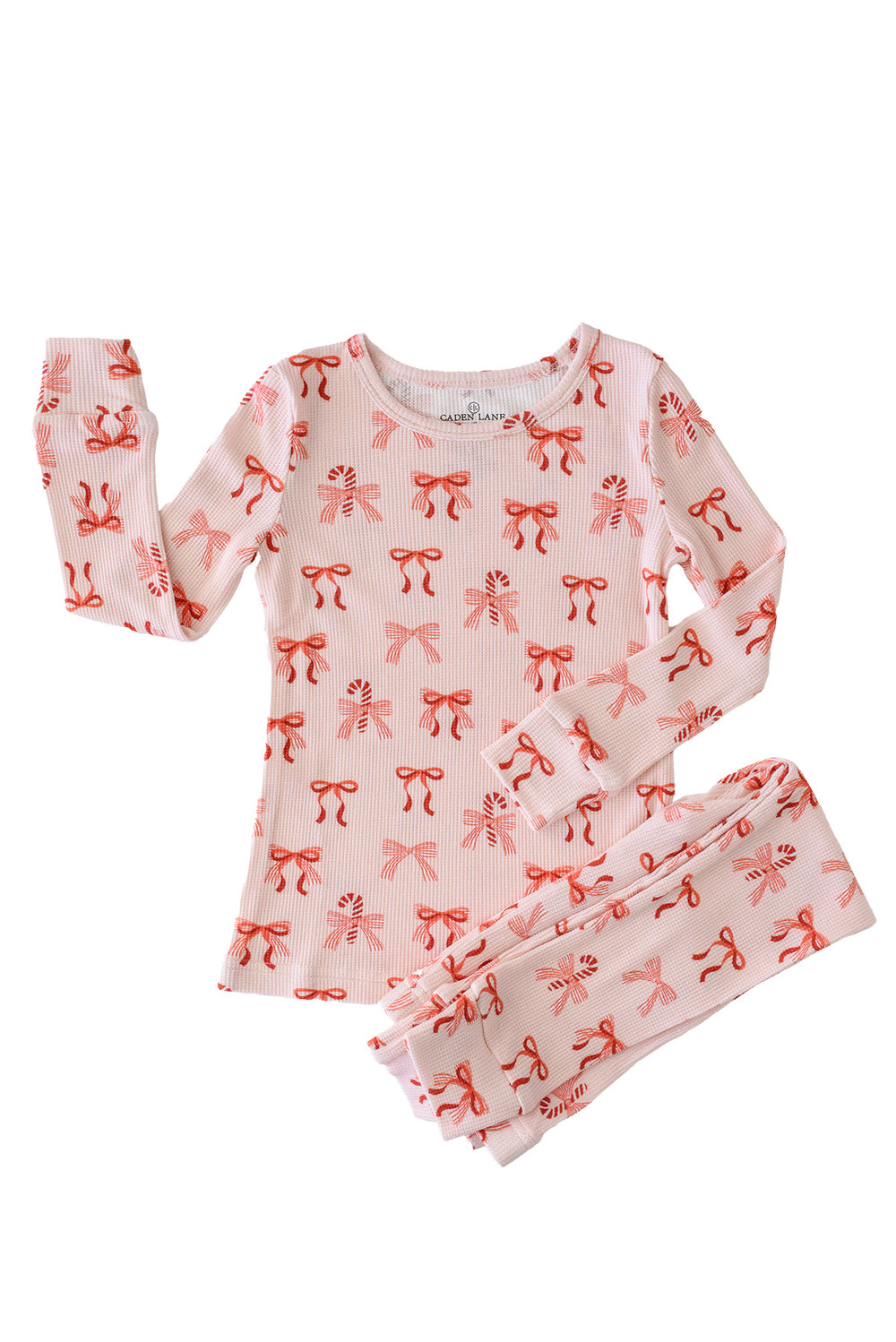 Flat lay of the Caden Lane Peppermint Bows Bamboo Waffle Two-Piece Pajama Set, crafted from premium bamboo viscose waffle knit with a festive peppermint bow and candy cane print for matching Christmas pajamas.