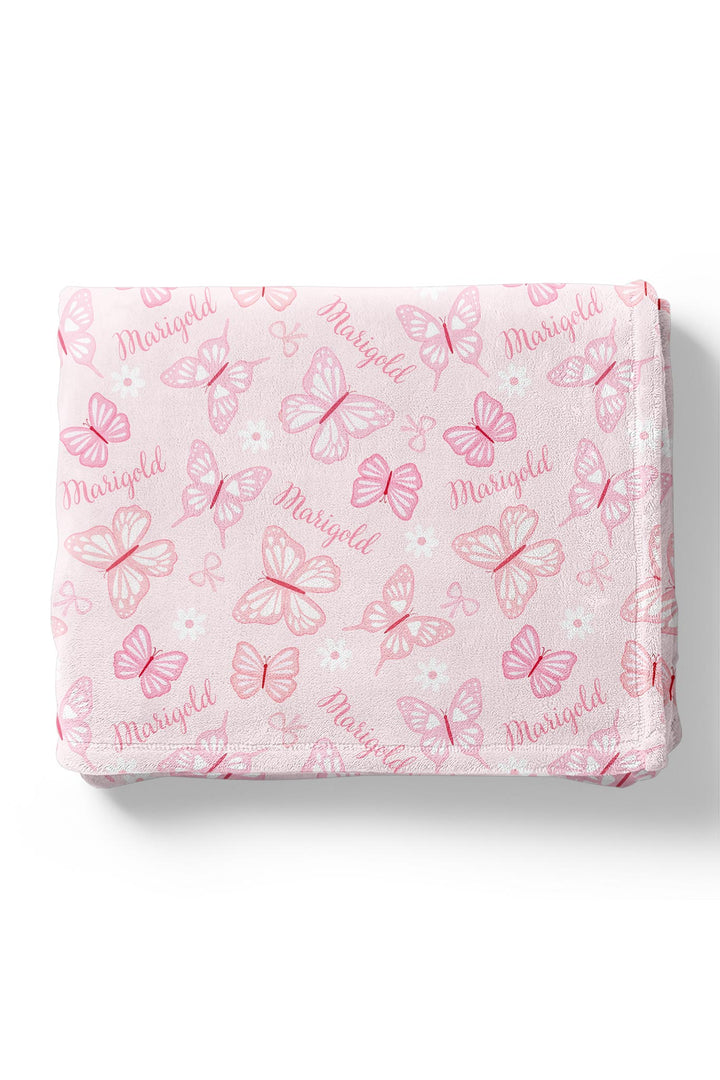 Personalized Kids Blanket in Blooming Butterflies print - blanket folded into a square, showing the pink butterfly print with personalized name repeated throughout the design