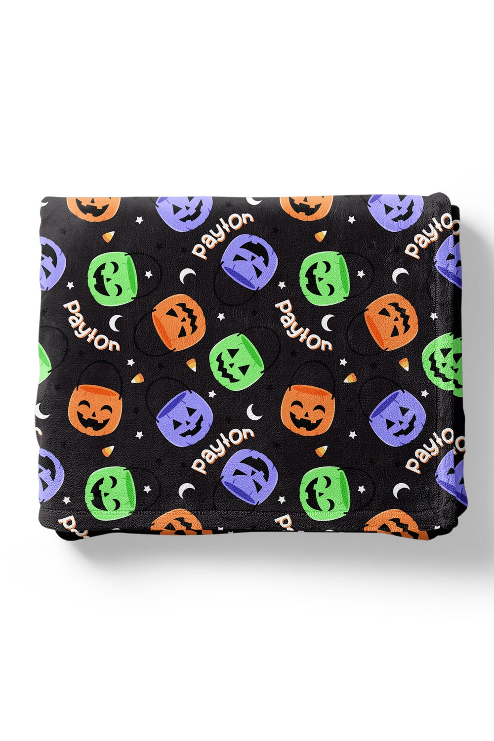 Folded personalized Halloween blanket with repeating name text and colorful jack-o-lantern candy bucket print