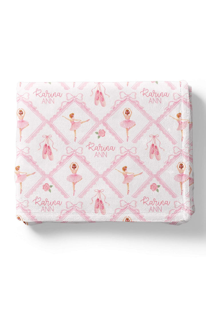 Folded Caden Lane ballerina and roses pink print personalized blanket embroidered with the name 'Karina Ann,' flat lay on a white background