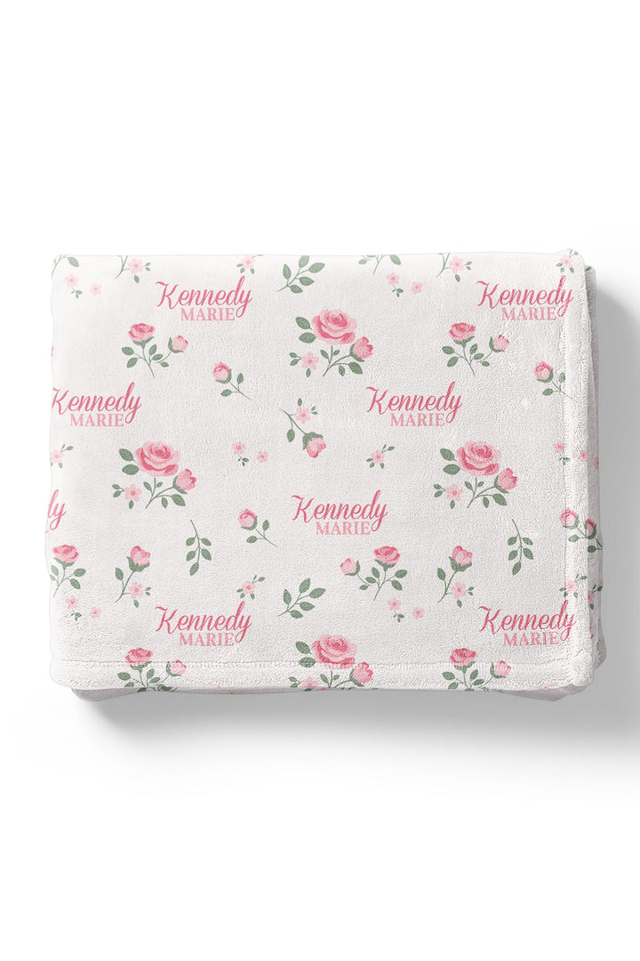 Caden Lane personalized baby blanket, folded, Rose Garden White floral pattern with custom name