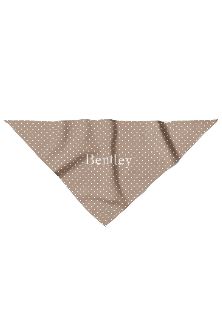 Flat lay of latte brown polka dot pet bandana in a triangle shape with personalized name in white text