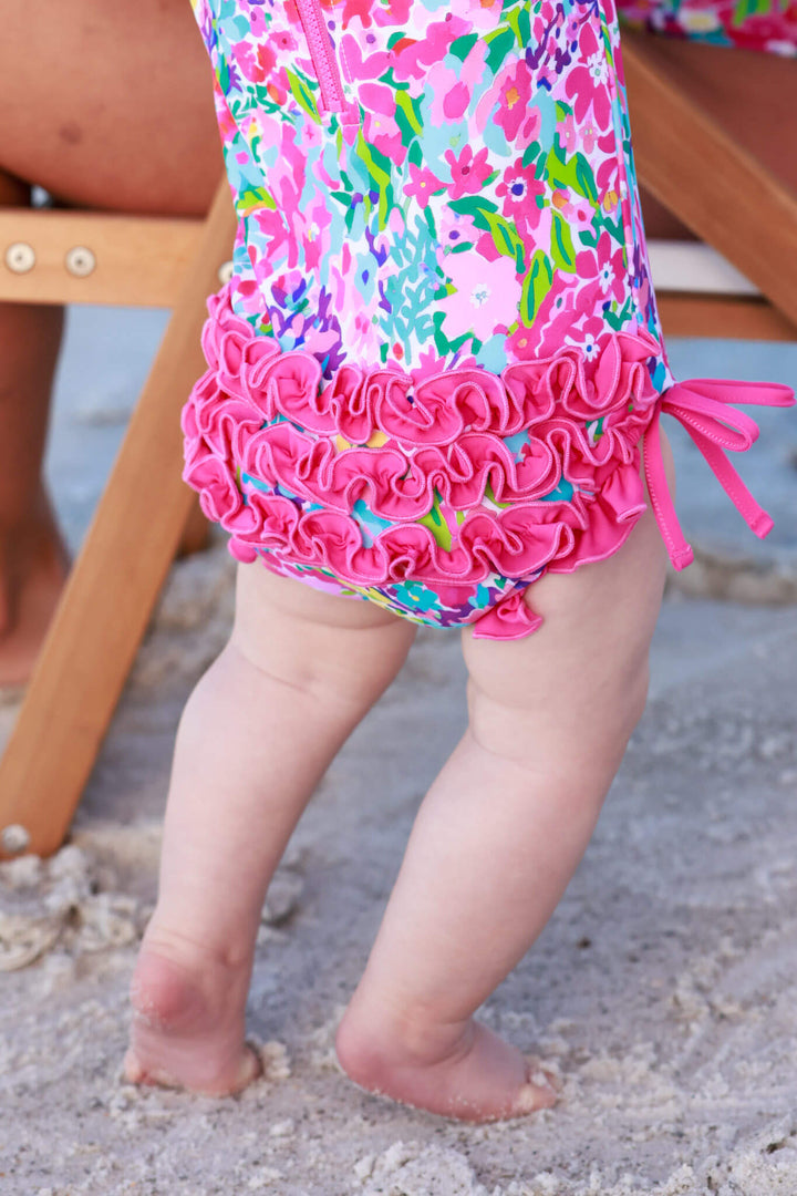 pink ruffle bottom long sleeve swimsuit for girls in petal splash print