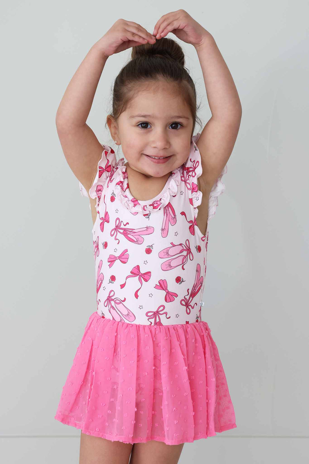 girl doing ballerina pose in ballet leotard for girls 