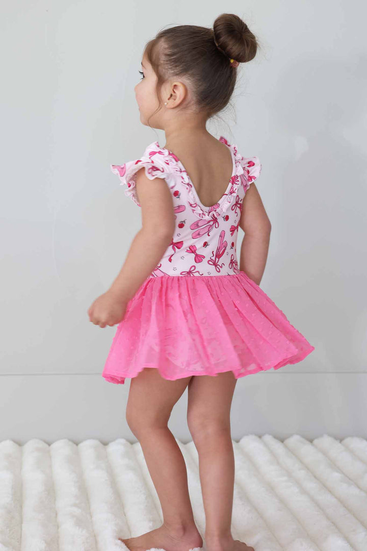 girl twirling around in pink pirouette leotard with tulle skirt 