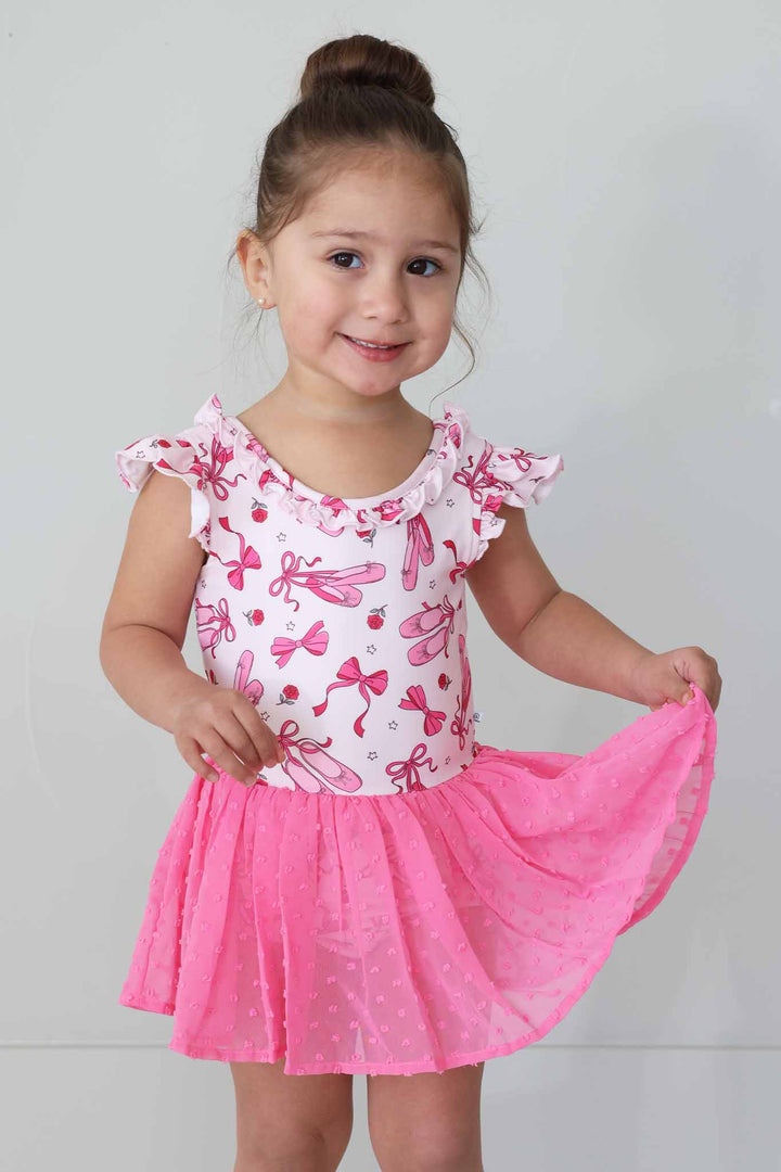 girl wearing pink pirouette leotard with hot pink tulle skirt 