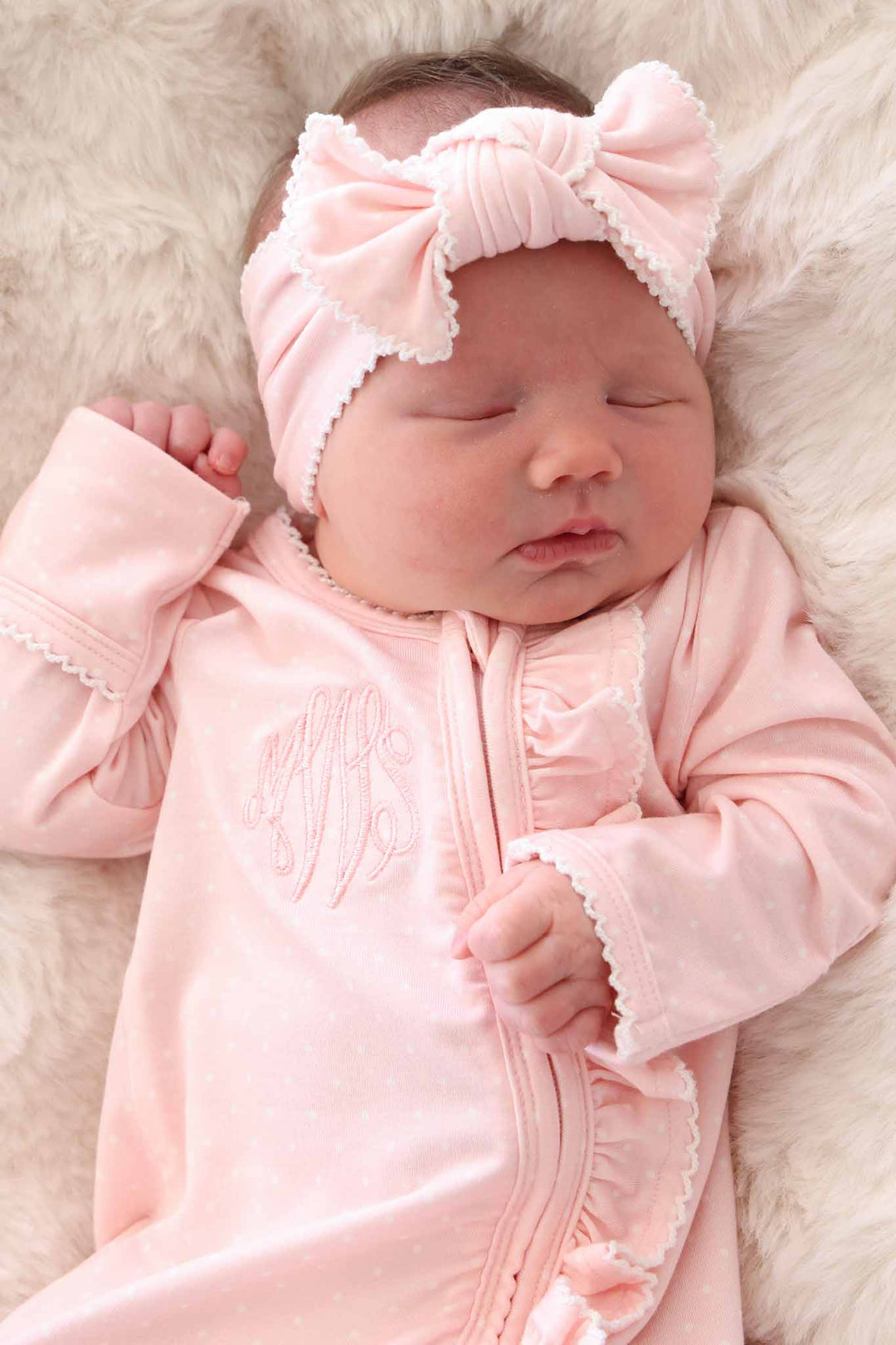 newborn wearing pink bamboo bow headwrap with picot trim