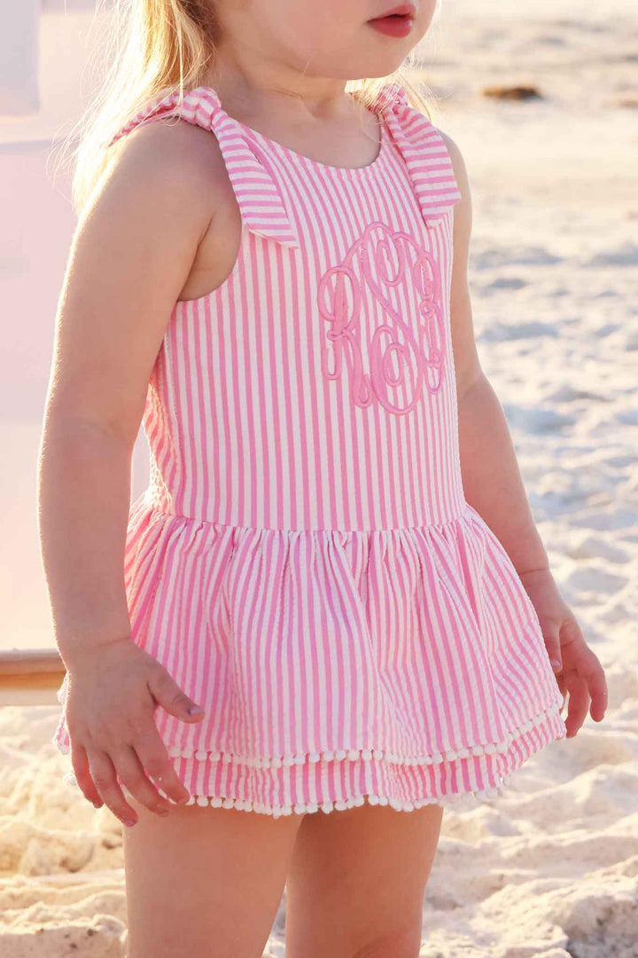 side view on pink seersucker embroidered one piece for girls with bow straps 