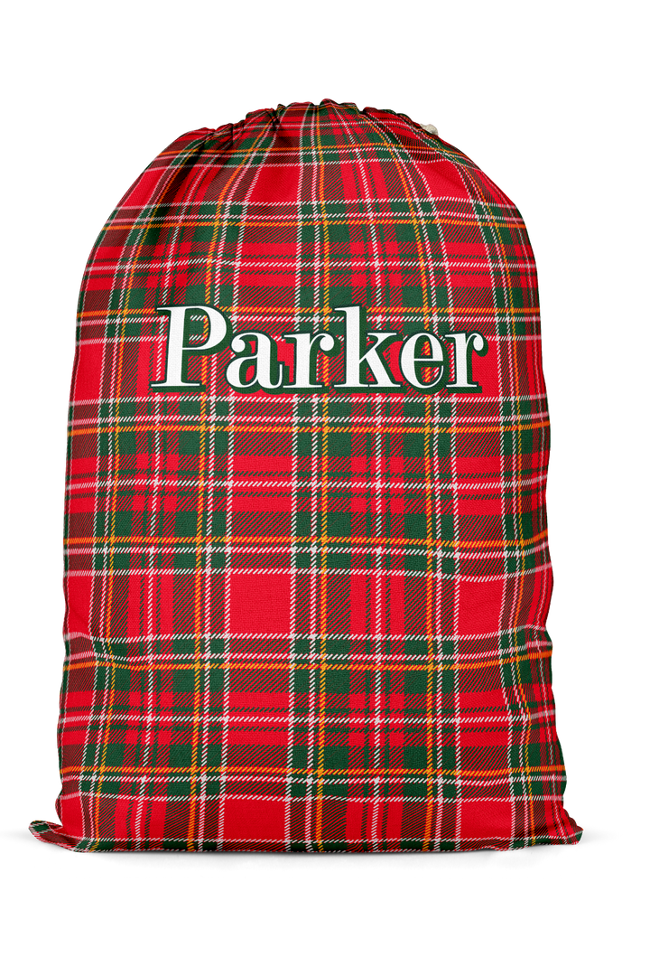 Caden Lane personalized Christmas Santa sack featuring a custom name on a classic red and green plaid design, perfect for holiday gift storage, matching family pajamas, and festive Christmas traditions.
