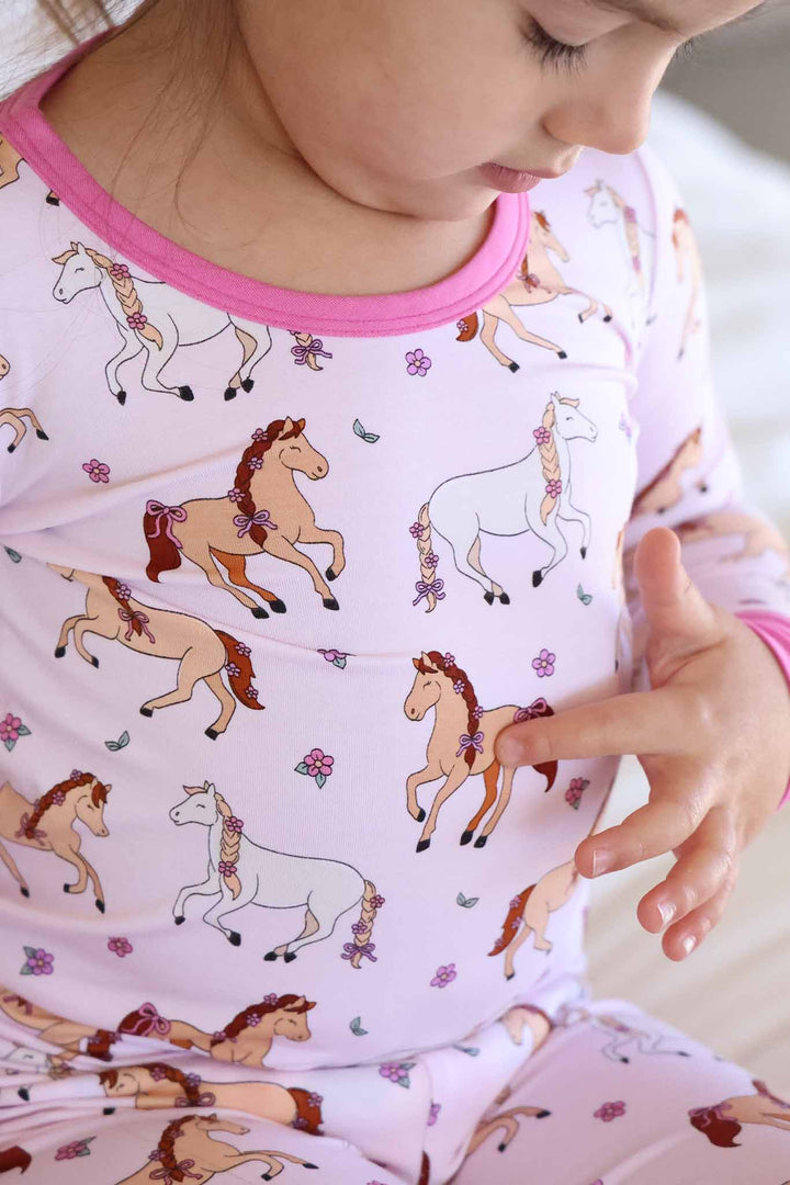 closeup of pony club pink two piece pajama set for girls 