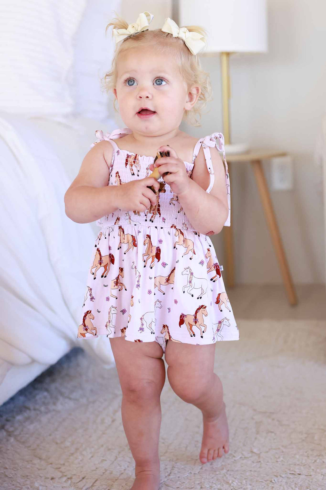 toddler girl walking wearing pony club pink spaghetti strap smocked skirt bodysuit 