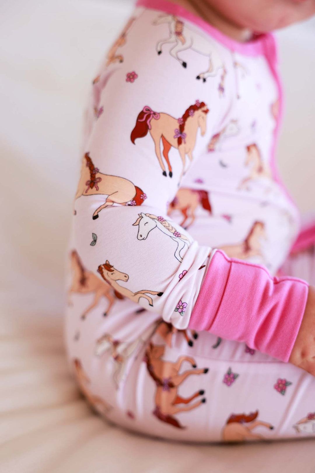 closeup of pink pony club convertible zip romper for girls 