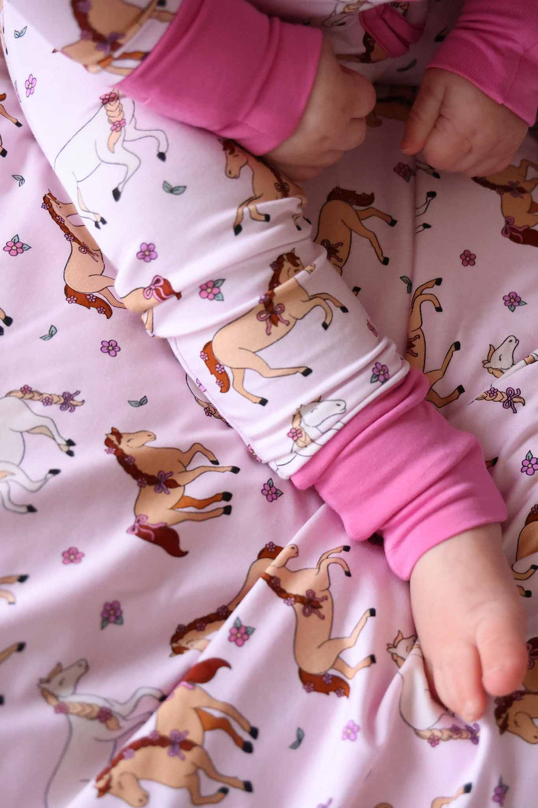 closeup of leg on pony club pink convertible zip romper 