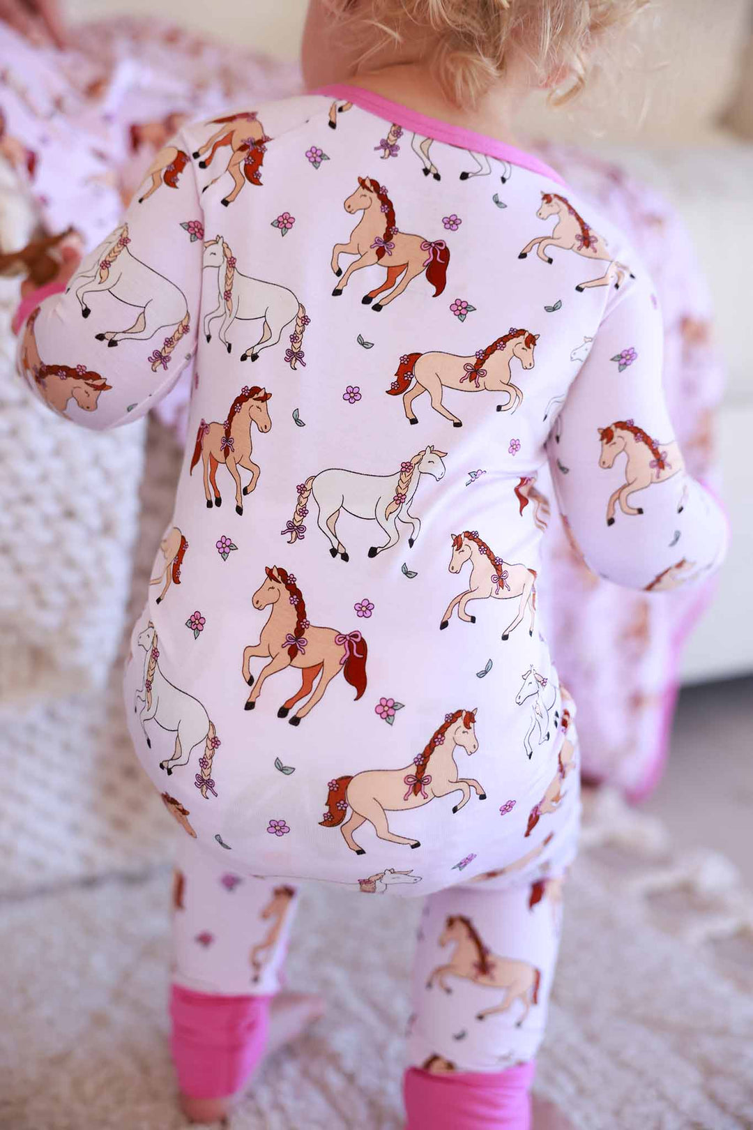 back view of pony club pink convertible zip romper 