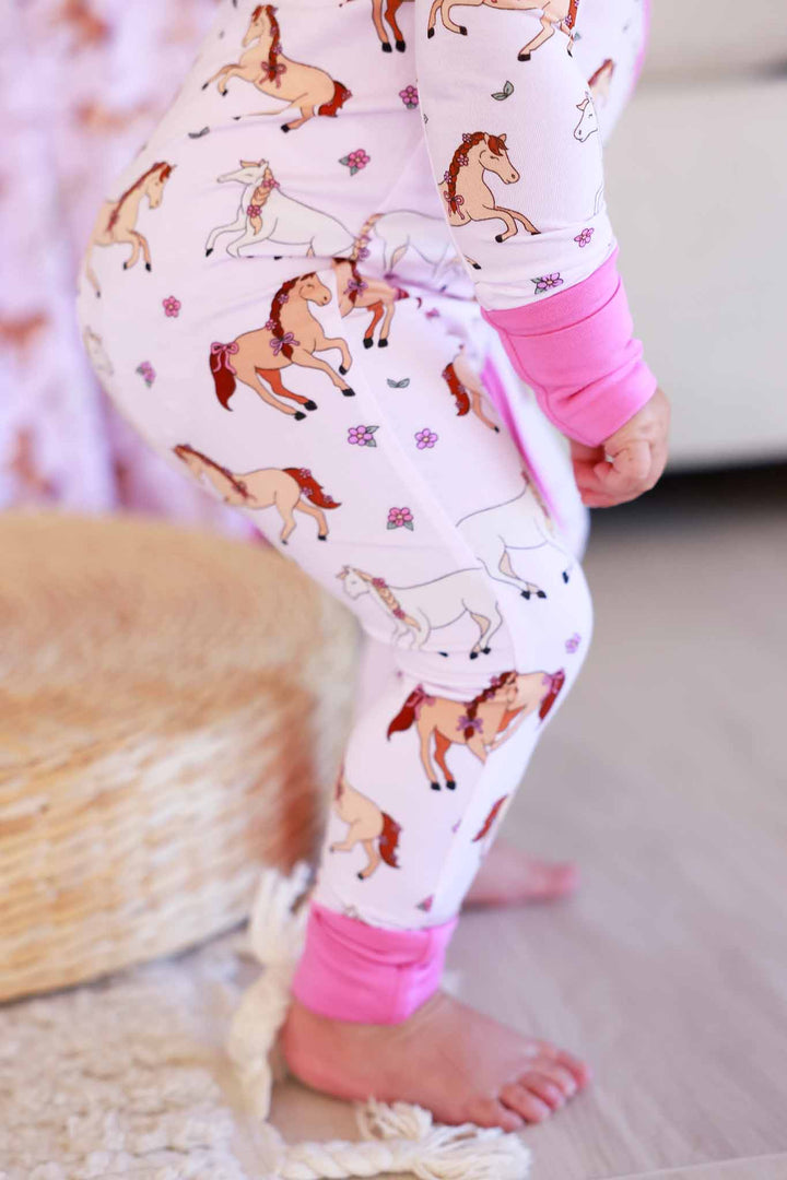closeup of pony club pink girly horse and flower convertible zip romper for girls 