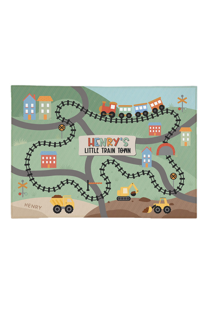 Caden Lane personalized 5x7 train play rug with tracks, roads, trucks and a town, reading "Henry's Little Train Town"