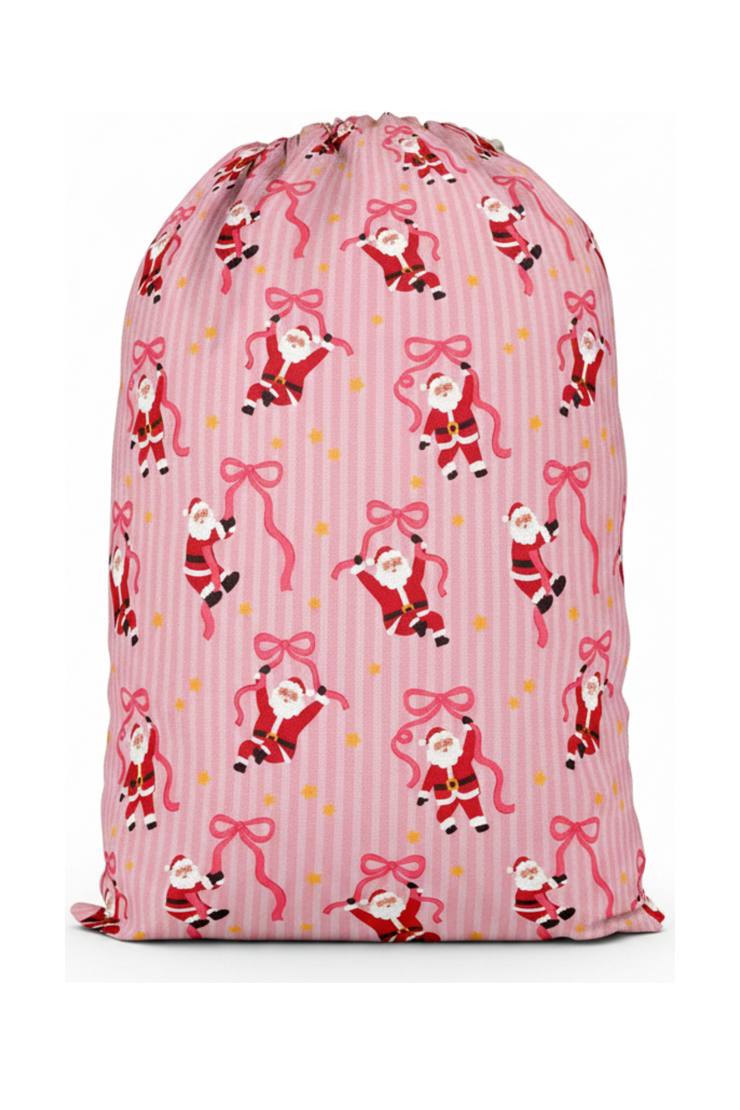 Caden Lane Jolly Ribbons Personalized Christmas Santa Sack back featuring an exclusive Santa and ribbon print on pink stripes, coordinating with matching family pajamas and holiday accessories.