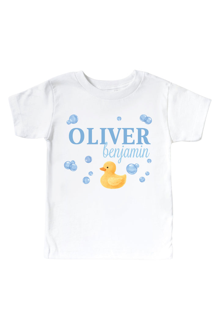 White kids t-shirt with personalized blue bubble duckie graphic design featuring yellow rubber duck, blue bubbles, and custom name on front