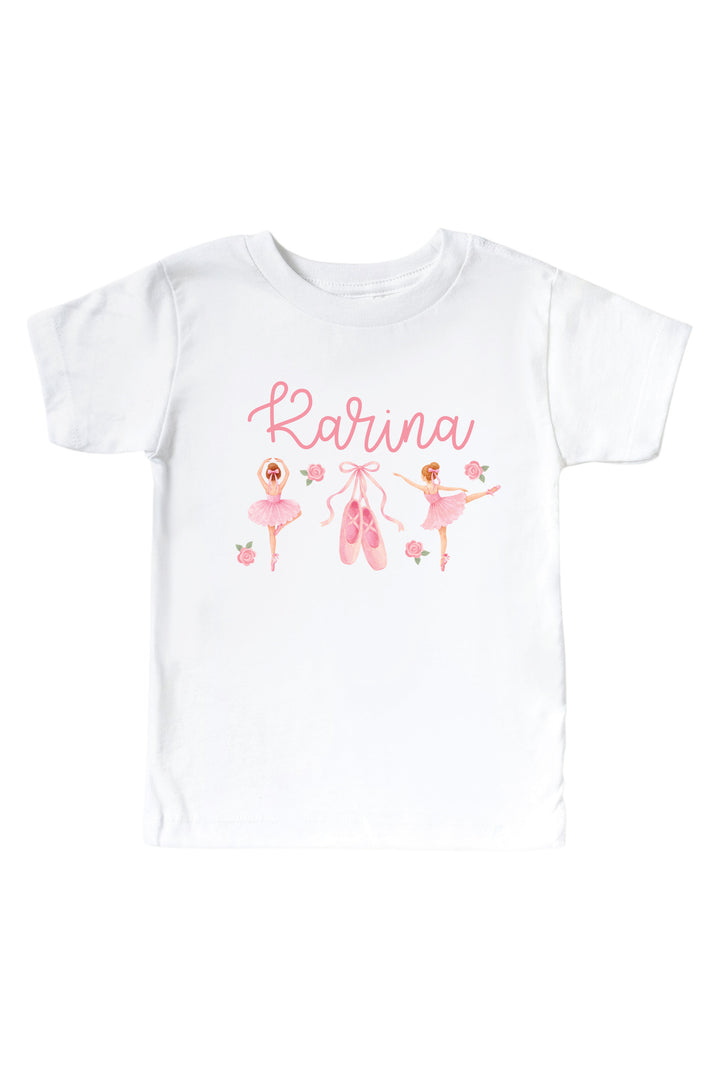 A white short-sleeve baby t-shirt featuring a pink graphic print with the name 'Rarina' in cursive, accompanied by illustrations of ballerinas, ballet slippers, and small flowers.