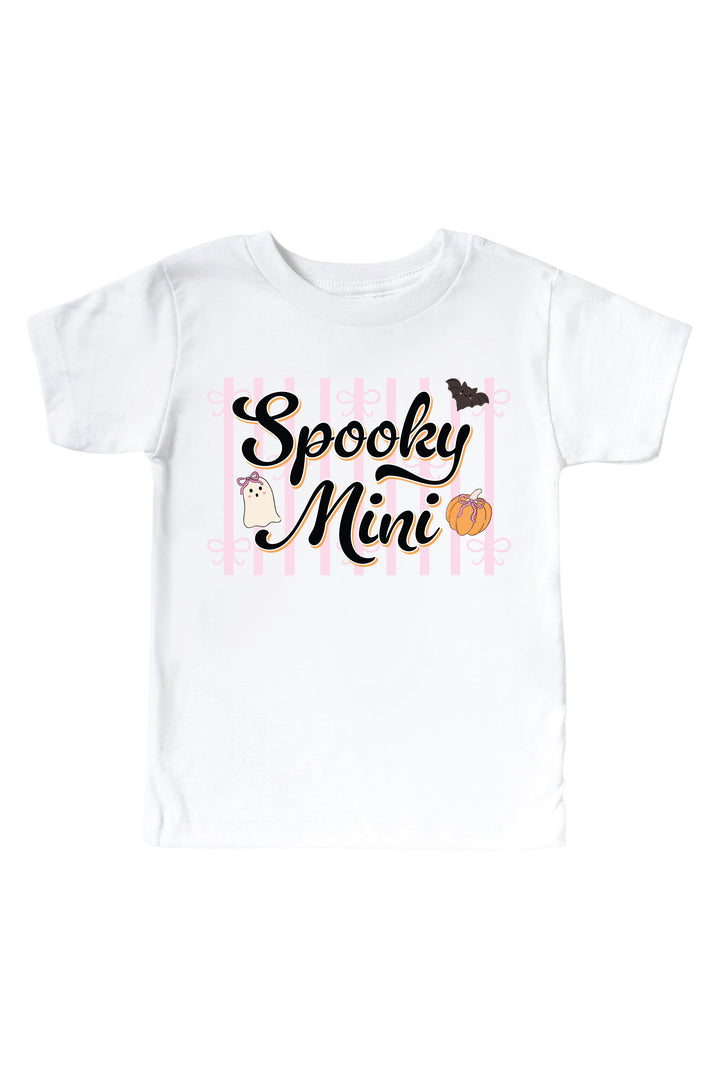 White kids' t-shirt printed with 'Spooky Mini' text and Halloween graphics of a pumpkin, bat, and ghost.