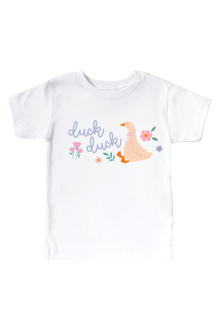 White kids graphic tee mockup with Duck Duck graphic featuring a goose with flowers and script text on a white background