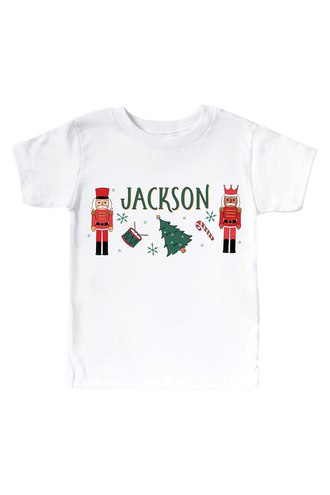 Caden Lane's white baby onesie personalized with the name "Jackson," featuring red toy soldier nutcrackers, a Christmas tree, drum, and candy cane, laid flat.
