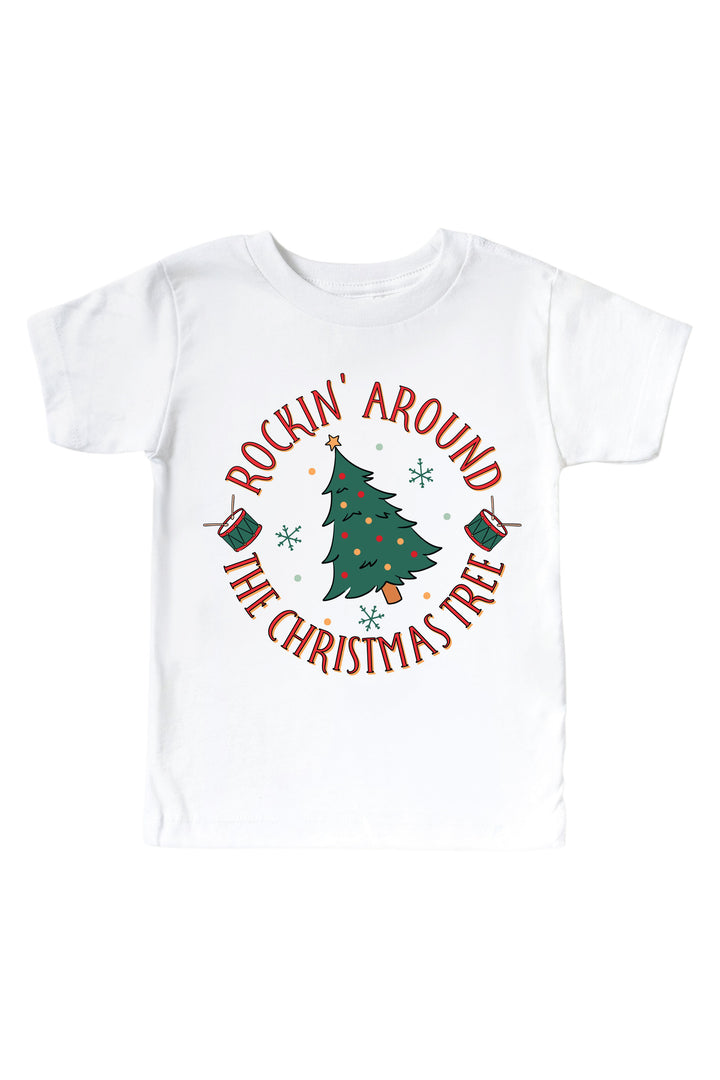 Caden Lane's white "Rockin' Around the Christmas Tree" toddler t-shirt featuring a decorated Christmas tree with drums and snowflakes, laid flat.
